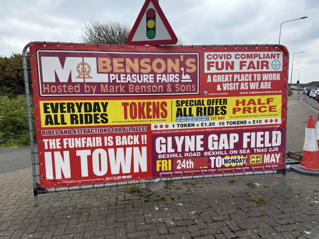 Funfair signs at Glyne Gap showing dates, opening times and token prices