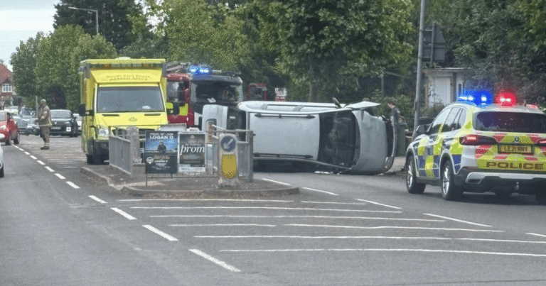 Overturned vehicle on Sedlescombe Road North in Hastings with police, ambulance and fire crews at the scene.