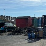 Burnt caravan, damaged car and partially destroyed beach hut at Cinque Ports Way in St Leonards-on-Sea following an early morning fire.