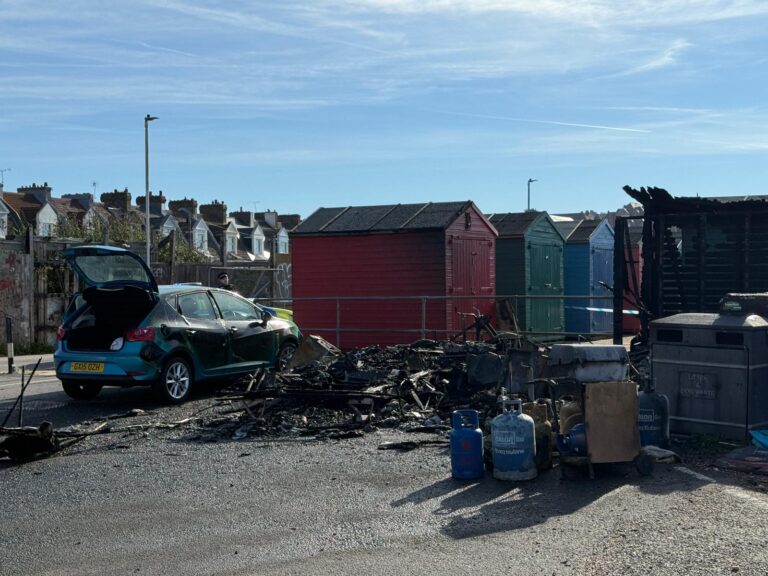 Burnt caravan, damaged car and partially destroyed beach hut at Cinque Ports Way in St Leonards-on-Sea following an early morning fire.