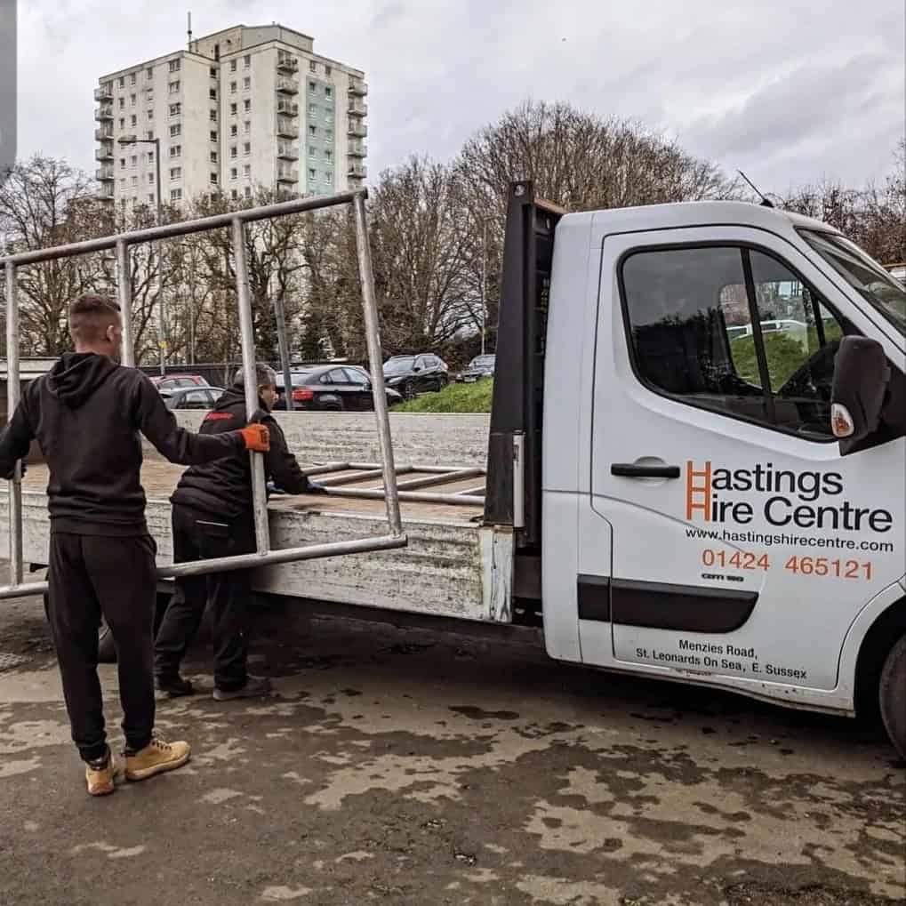 Staff loading scaffold tower sections onto a Hastings Hire Centre delivery vehicle