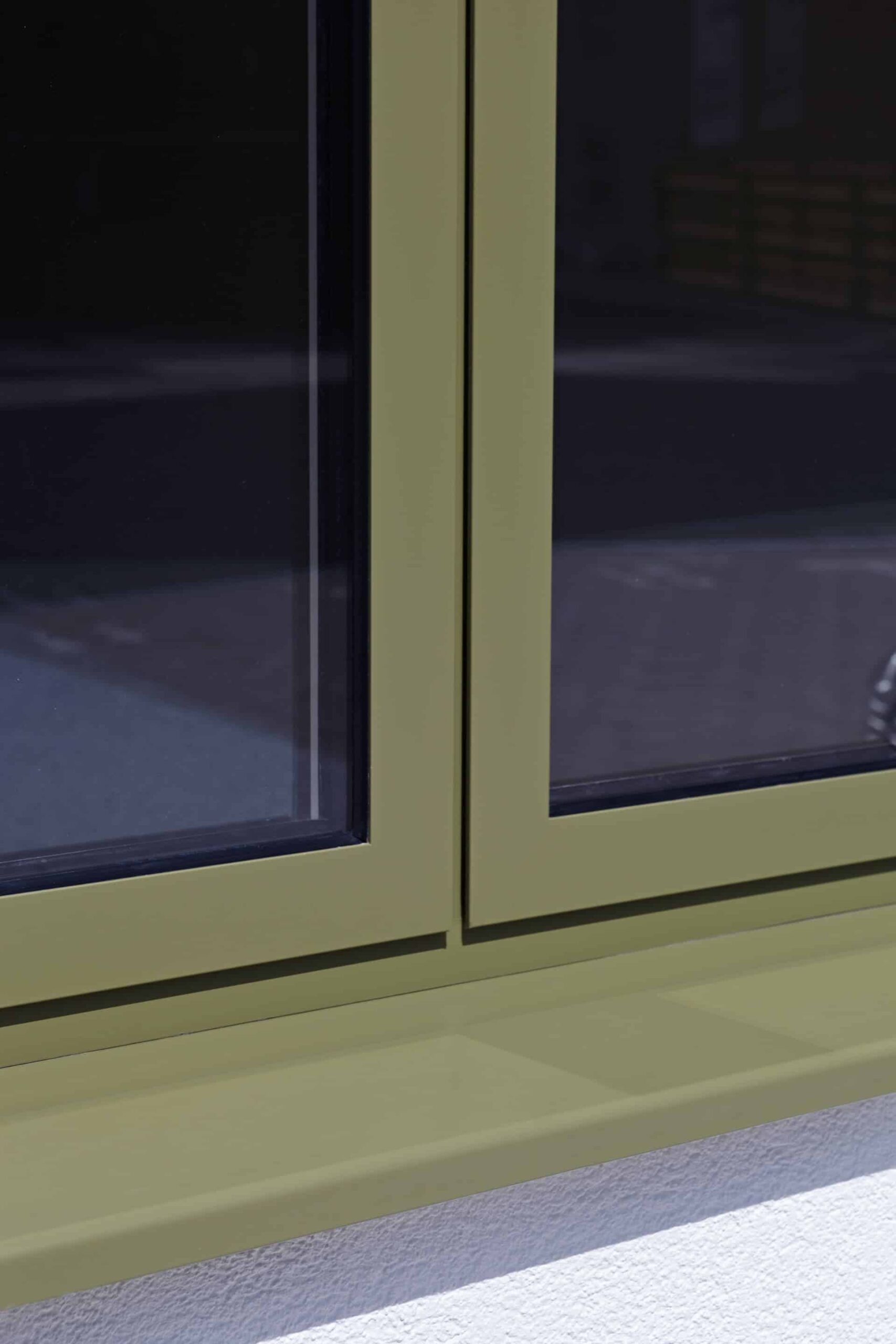 Close-up view of a powder-coated aluminium window frame and sill