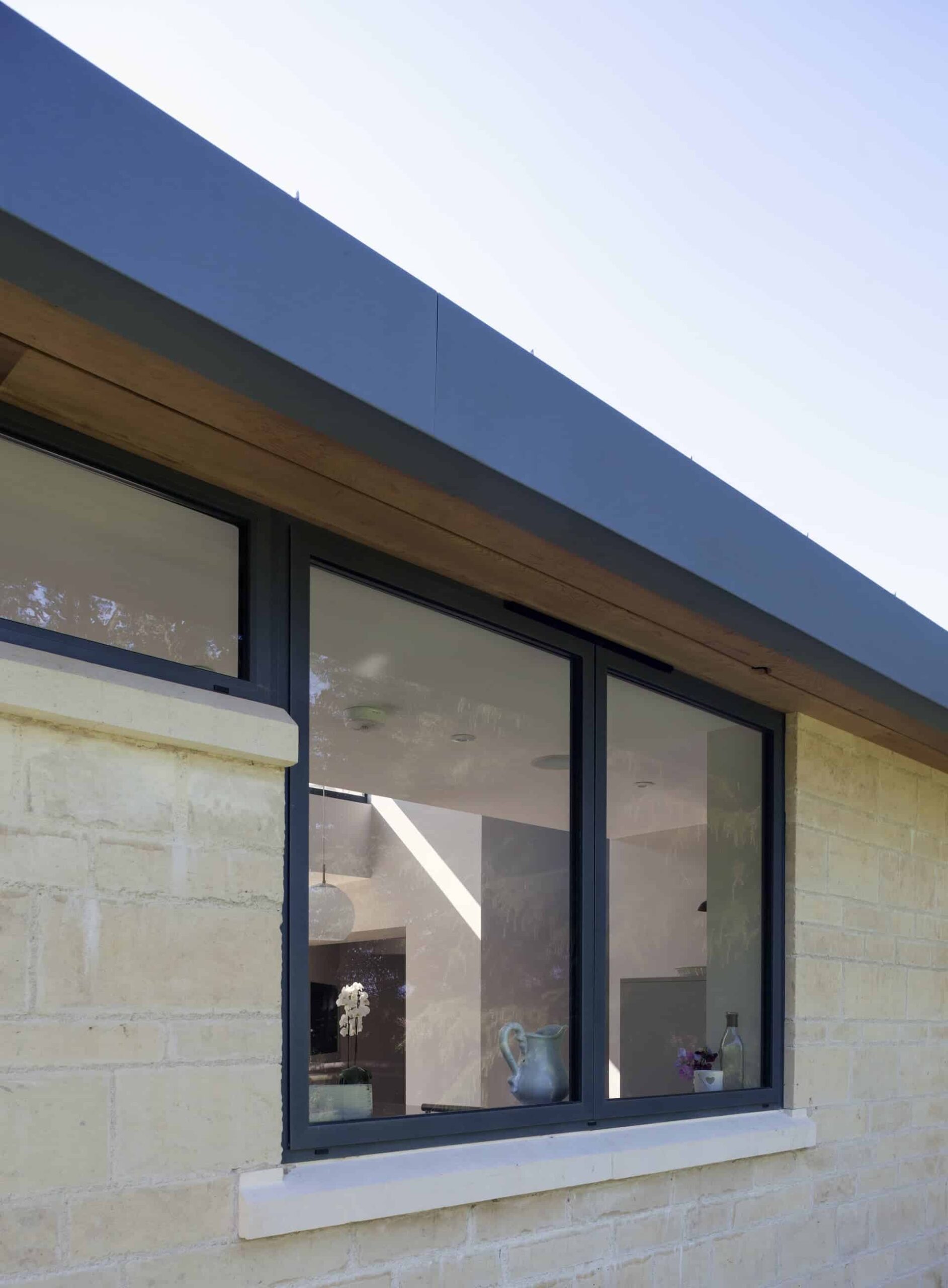 Contemporary aluminium-framed window fitted within a stone-built property