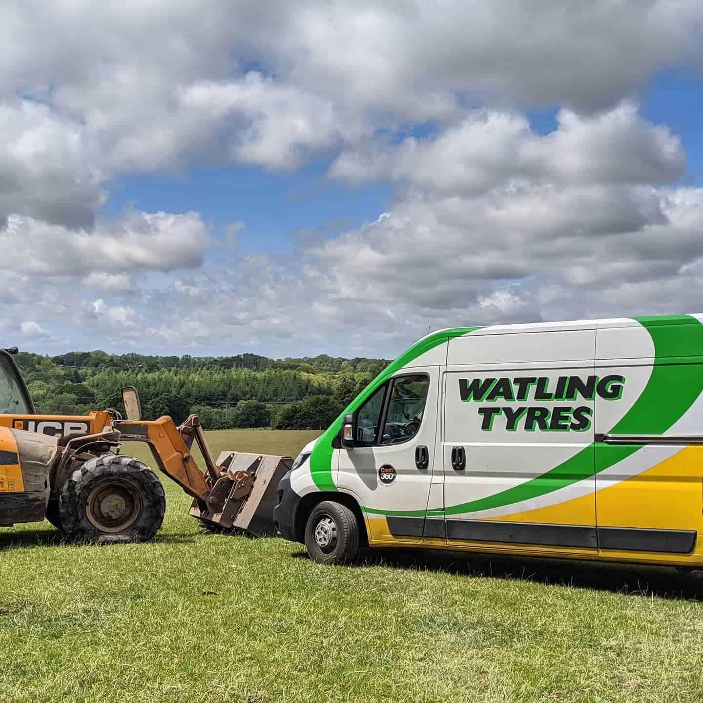 Watling Tyres mobile service van attending a tractor tyre repair in a grassy field.