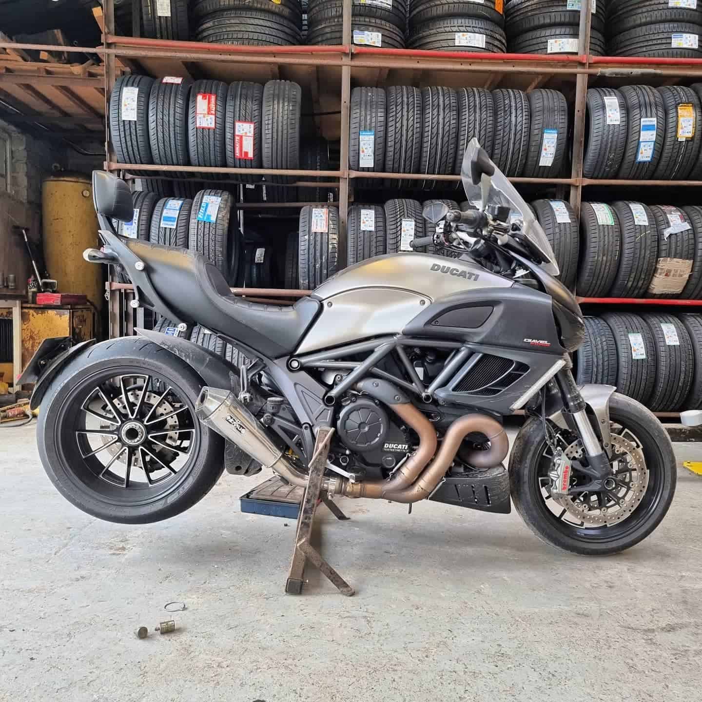 Motorcycle on a workshop stand during a tyre change at Watling Tyres in Hastings.